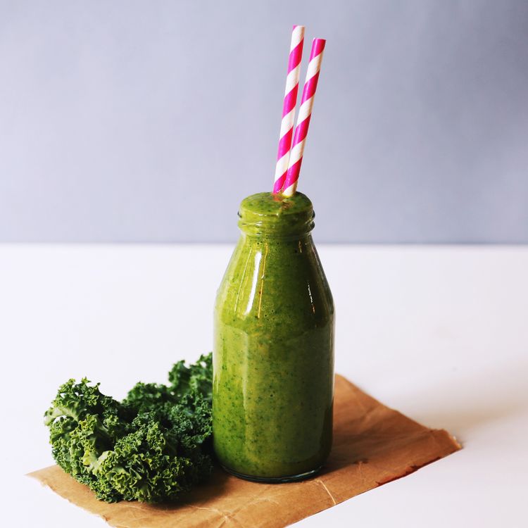 Golden glow green smoothie with turmeric, pineapple, and spinach in a glass
