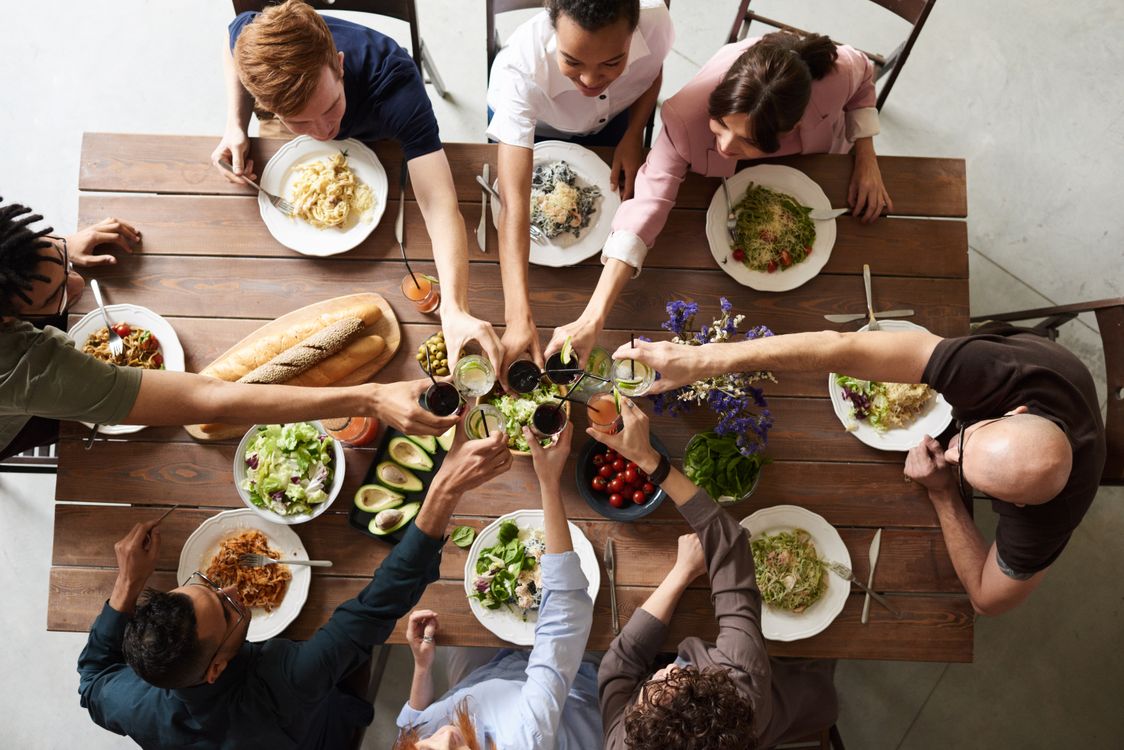 Anti-inflammatory foods including salmon, avocado, berries, leafy greens, and nuts arranged on a table