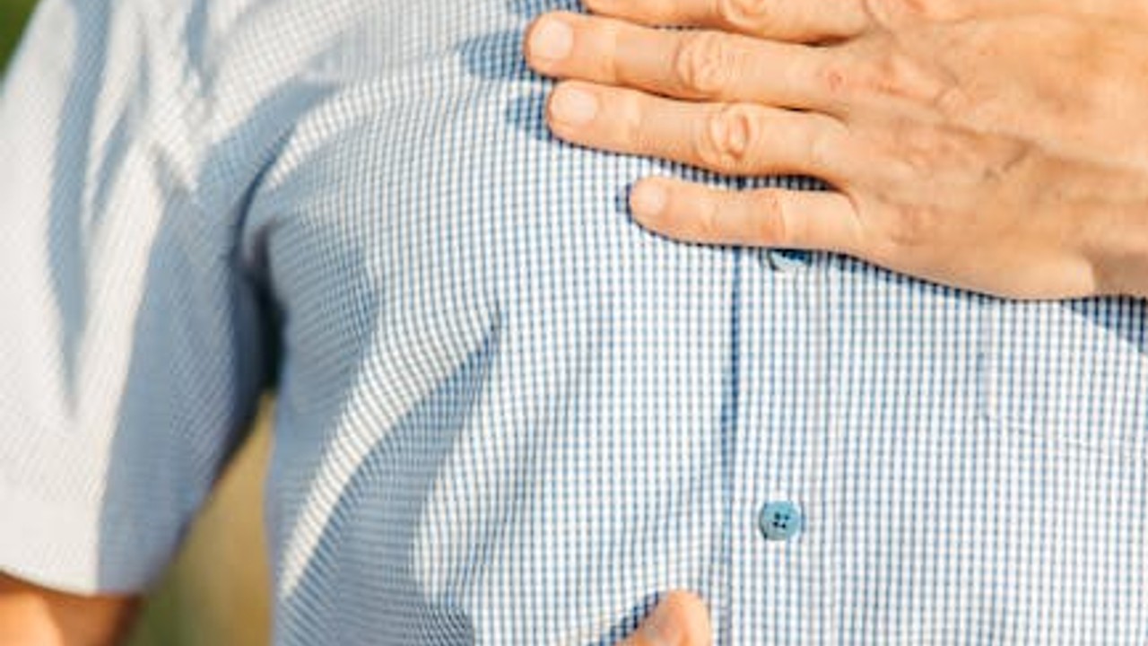 A person experiencing acid reflux discomfort