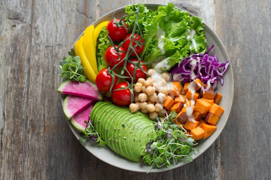 Vibrant assortment of colorful fruits and vegetables, symbolizing the variety of allowed foods on the AIP diet.